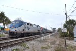 A late running Amtrak Floridian Train # 41 is about to pass the Sunrail LYNX Central Station with P42DCs # 150 and 138 as power